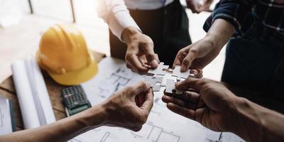 Team of engineer and architects working join hands to build successful projects. Teamwork concept. photo