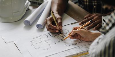 Team construction engineers working at construction site with blueprint on table photo