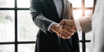 Business people shaking hands, finishing up meeting, business etiquette, congratulation, merger and acquisition concept photo