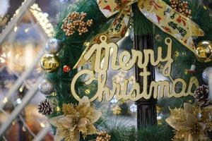 Close up gold Merry Christmas word at wreath photo
