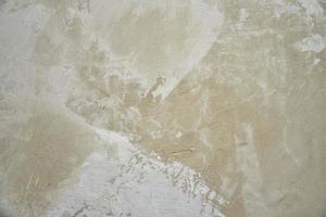 The gray wall is plastered with fresh cement mixture in the house. Work on repairing the wall in the house with a building mix. photo