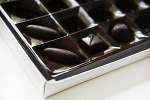 A box of chocolates on a white background. Delicious sweet candies in a box. photo