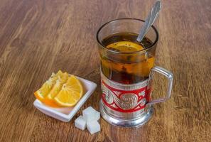 sweet cup of fruit tea with lemon and sugar. photo