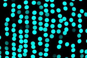 Unfocused abstract colourful bokeh black background. defocused and blurred many round blue light photo