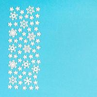 Top view of winter ornament made of white snowflakes on colorful background. Happy New Year concept with copy space photo
