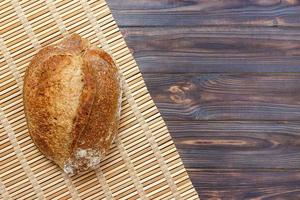 Fresh bread on wooden table. Top view with space for your text photo