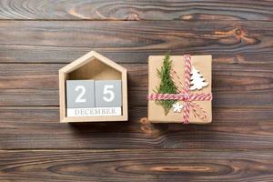 Christmas calendar 1 december. Christmas gift, fir branches on wooden white background. Copy space, top view photo