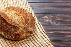 Fresh bread on wooden table. Top view with space for your text photo