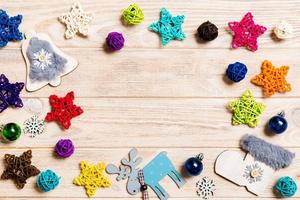 Top view of Christmas decorations and toys on wooden background. Copy space. Empty place for your design. New Year concept photo