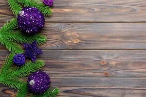 Christmas composition made of fir tree, balls and different decorations on wooden background. Top view of New Year Advent concept with empty space for your design photo