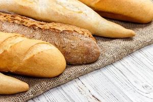 different types of baguette on a wooden background photo
