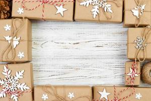 New Year and Christmas Frame Composition. handmade wrapped christmas gift boxes with decoration on white background with empty copy space for your text. above view, flat lay photo