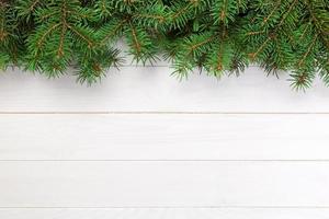 Christmas wooden background with fir tree and copy space. top view empty space for your design photo