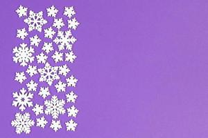 Top view of white snowflakes on colorful background. Winter weather concept with copy space. Merry Christmas concept photo