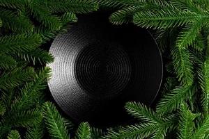 Top view served plate with green fir tree branches. Holiday dinner concept with copy space photo