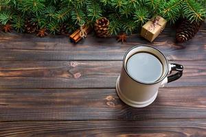 Mug of coffee on black wooden christmas background. top view, copy space photo