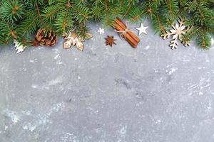 Christmas background with fir tree and gift box on wooden table. Top view with copy space for your design photo