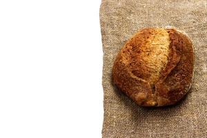 freshly baked bread on napkin isolated on white background photo