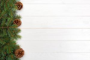 Christmas wooden background with fir tree frame and cone copy space. top view empty space for your design photo
