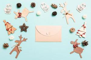 Top view of envelope on blue background. New Year decorations. Christmas holiday concept photo