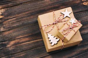 Christmas wooden decorations with snowflakes, white stars and Xmas trees on a background of black vintage old wooden boards. Background for your text and design photo