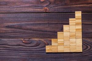 A wooden blocks cube over black wooden textured background with copy space for add word text title. Concept or conceptual Wood block stair or six steps. Cubic photo