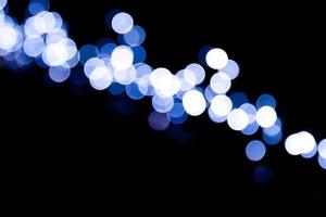 Unfocused abstract colourful bokeh black background. defocused and blurred many round blue light photo