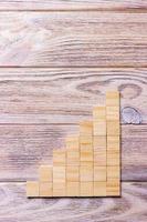 A wooden blocks cube over black wooden textured background with copy space for add word text title. Concept or conceptual Wood block stair or seven steps. Cubic photo