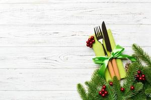 Top view of festive cutlery on new year wooden background. Christmas decorations with empty space for your design. Holiday dinner concept photo