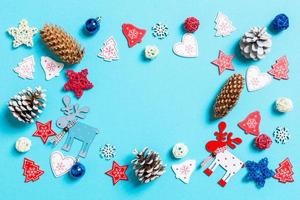 Top view of New Year toys and decorations on blue background. Christmas time concept with empty space for your design photo