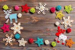 Top view of Christmas decorations and toys on wooden background. Copy space. Empty place for your design. New Year concept photo