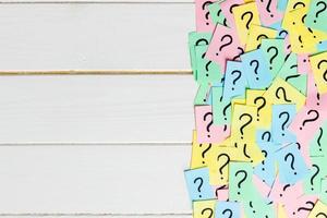 Concept for confusion, question or solution. question mark on wooden background photo