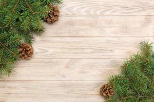 Christmas gray wooden background with fir tree frame and cones copy space. top view empty space for your design photo