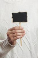 Girl holding an small blackboard isolated on white background photo