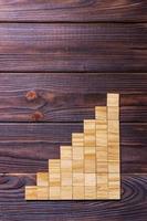 A wooden blocks cube over black wooden textured background with copy space for add word text title. Concept or conceptual Wood block stair or eight steps. Cubic photo