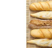 baguette of whole wheat bread on a white background photo