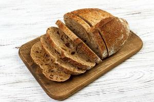 french sliced bread on wooden cutting board photo