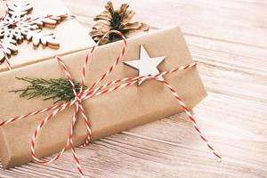 Christmas gift boxes on wooden table with snowflake. Top view with copy space. Toned photo