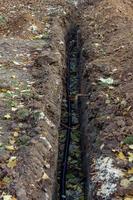 electric cables in trench, construction site excavations photo