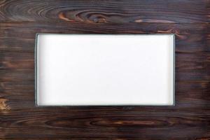 Empty opened white cardboard box for mock up on dark wooden table with copy space photo
