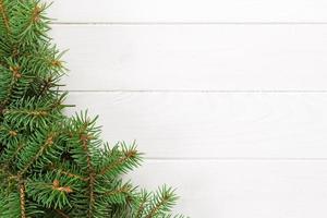 Christmas wooden background with fir tree and copy space. top view empty space for your design photo