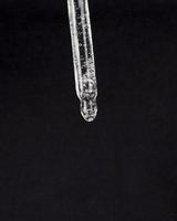 pipette with medicine on a black background, cannabis extract drop photo
