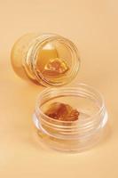 bottles of amber golden cannabis wax with high THC content photo