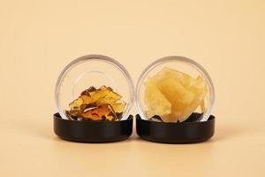 yellow extract wax from cannabis buds in container, marijuana thc distillate photo