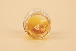 yellow cannabis wax in glass container, golden thc dab photo