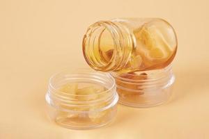 bottles of amber golden cannabis wax with high THC content photo