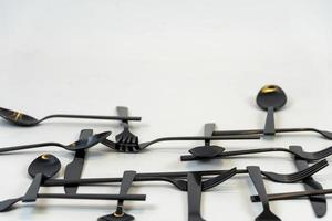 black metal forks and spoons on a white background, mexico photo