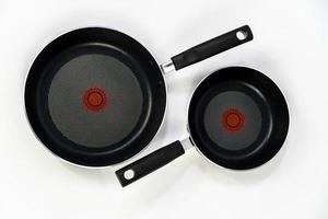 teflon cooking pans, black teflon on white background, plastic handles, mexico photo