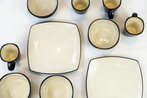 white ceramics bowl isolated on white background. plates and bowls arranged black color the frets photo