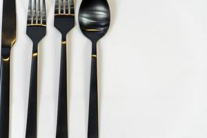 Rack of kitchen utensils, isolated on white. Stainless steel with black handles. mexico photo